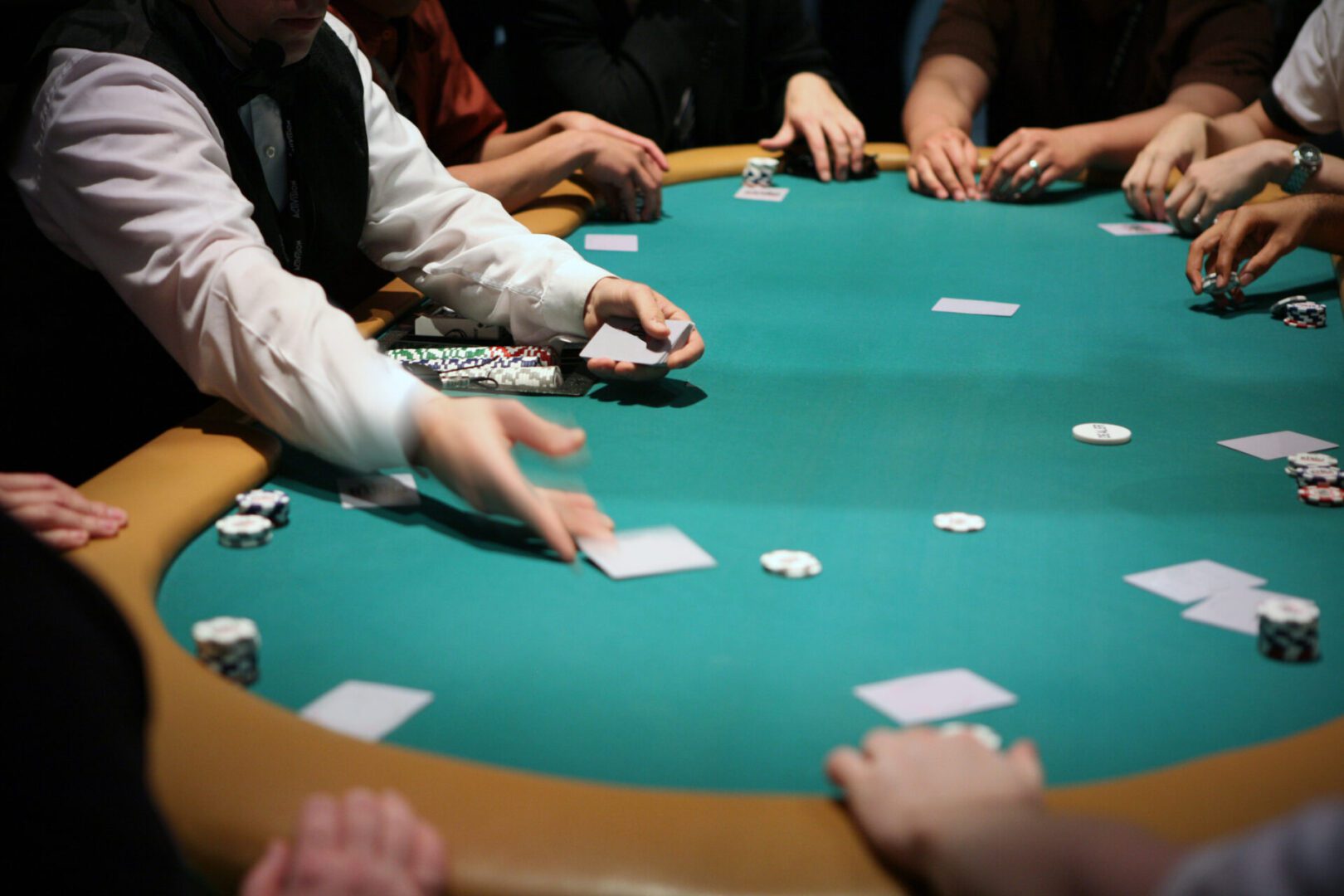 Poker game in progress at casino table.